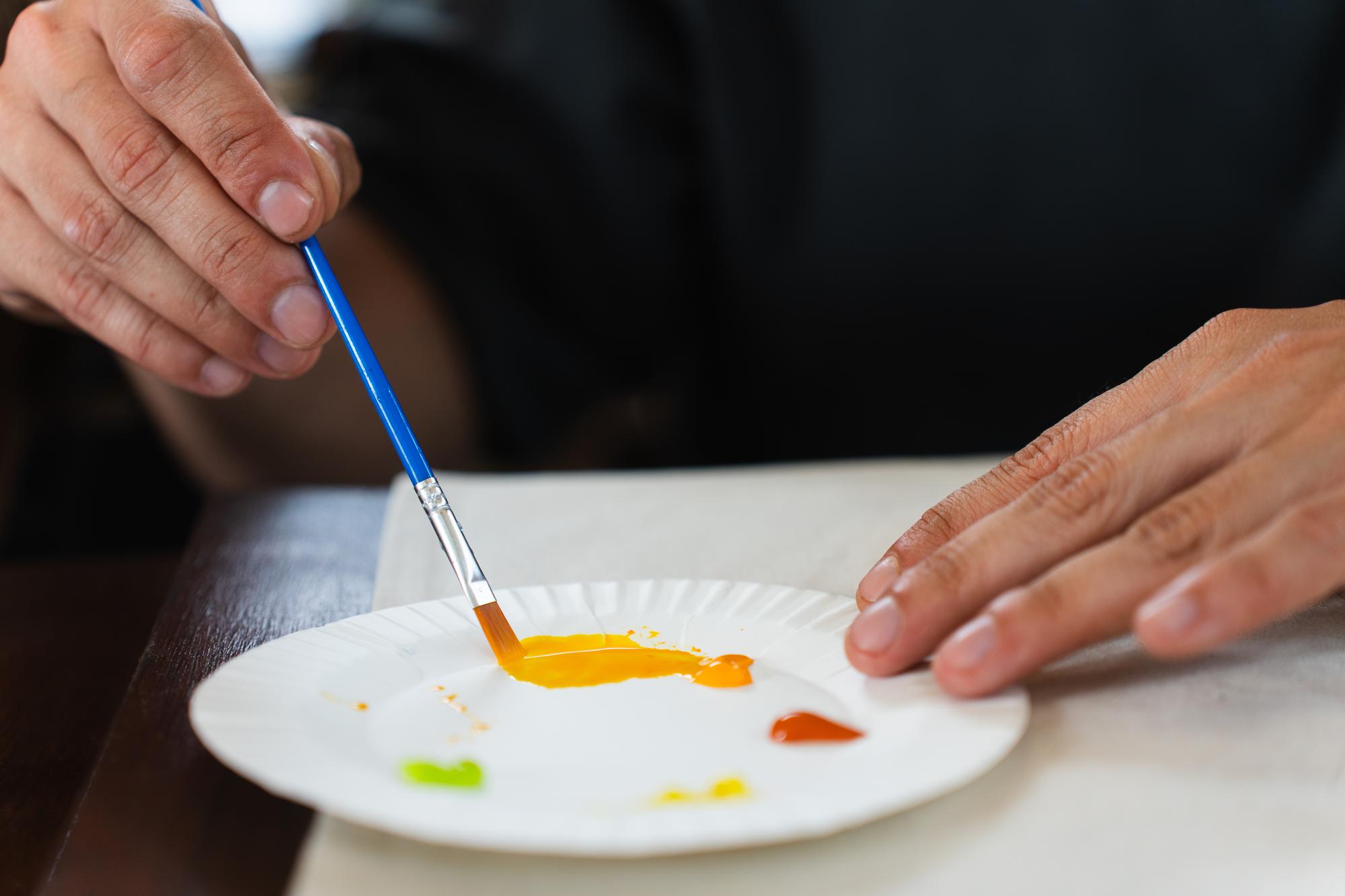 Chef arranging colorful plated dish in studio kitchen